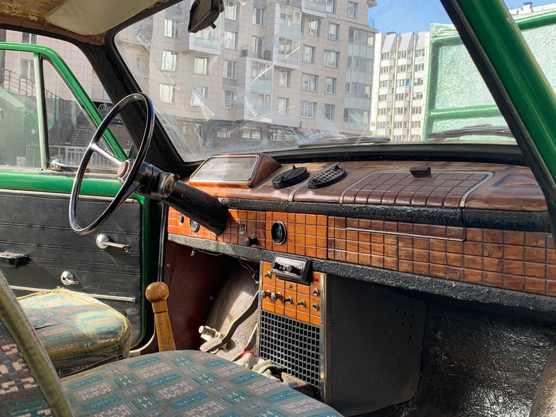 The interior of the Faux Lada. The guage cluster is from a ZAZ 966, and the oak dashboard was hand carved by Alexander Petrovych. That checkered pattern is very pleasing. Also: that shifter though.